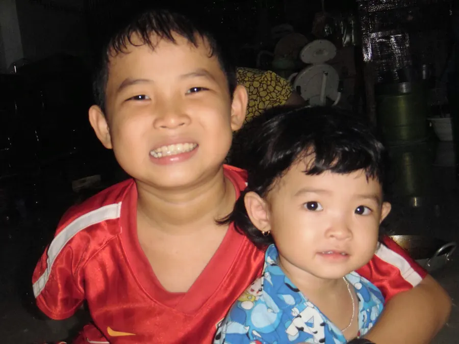 Two kids smiling at the camera